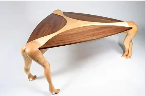 A wooden table with women's legs as erotic furniture
